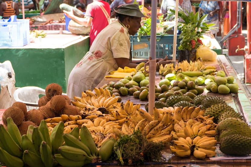 Vendor with bananas and tropical fruit at the Sir Selwyn Selwyn-Clarke Market, Victoria